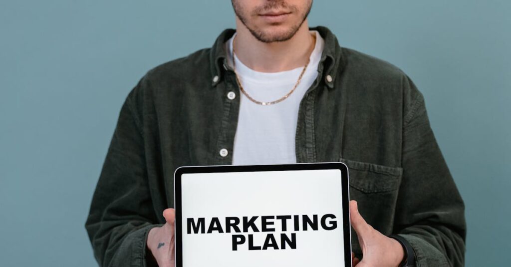 Adult wearing casual clothing holding a tablet that reads 'Marketing Plan'.